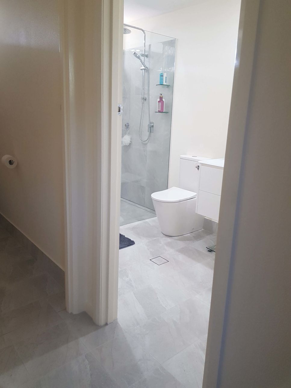 A Bathroom With a Toilet and a Walk in Shower — Omni Builders In Bungalow, QLD