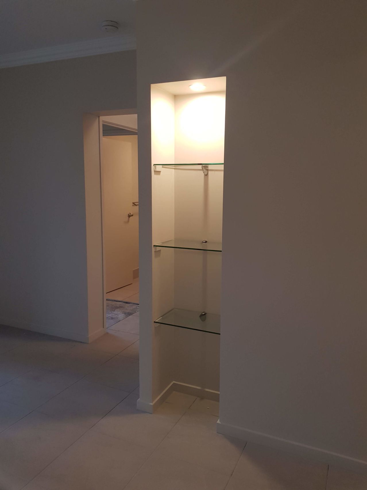 An Empty Room With a Glass Shelf in the Corner — Omni Builders In Bungalow, QLD