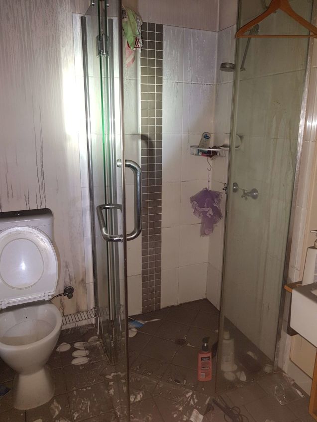 A Bathroom With a Toilet , Shower and Sink — Omni Builders In Bungalow, QLD
