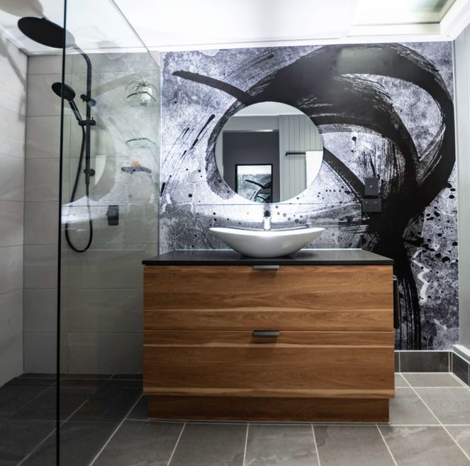 A Bathroom With a Sink a Mirror and a Shower — Omni Builders In Bungalow, QLD