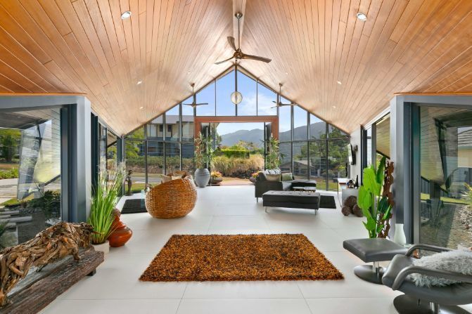 A Living Room With a Vaulted Ceiling and Lots of Windows — Omni Builders In Bungalow, QLD