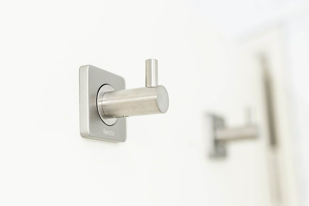 Two Stainless Steel Hooks Are Hanging on a White Wall — Omni Builders In Bungalow, QLD