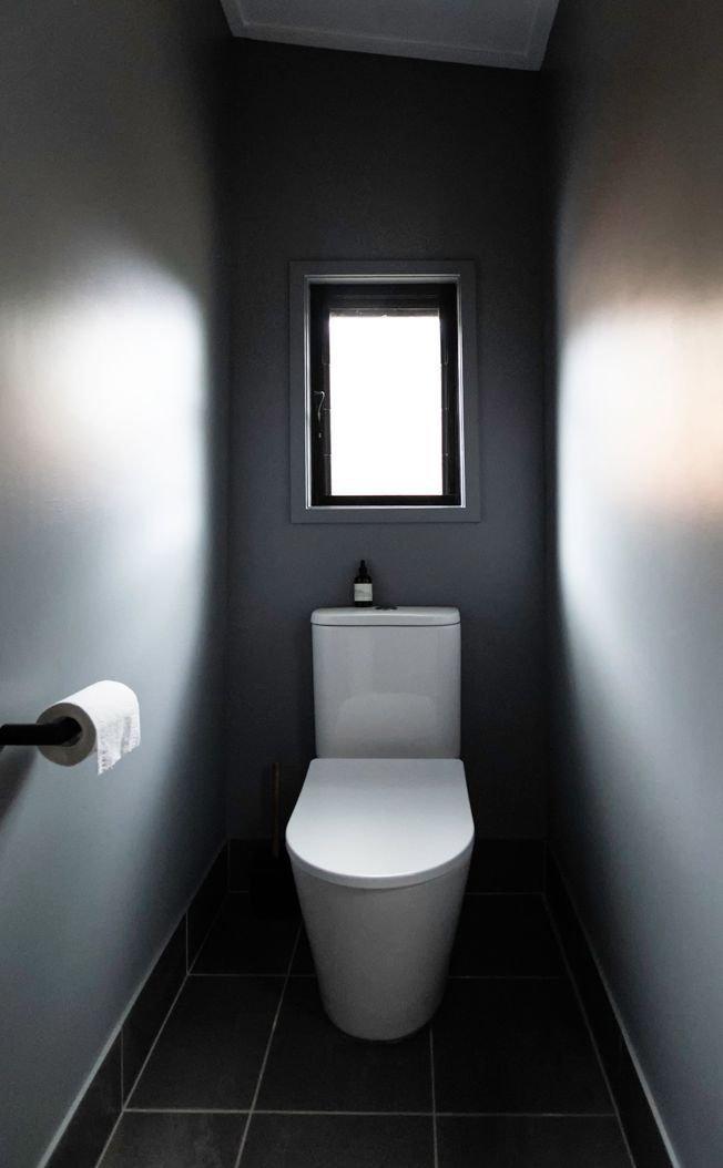 A Small Bathroom With a Toilet and a Window