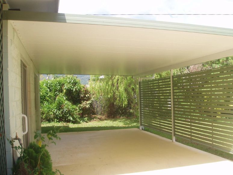 A Carport With a White Roof and a Green Fence — Omni Builders In Bungalow, QLD