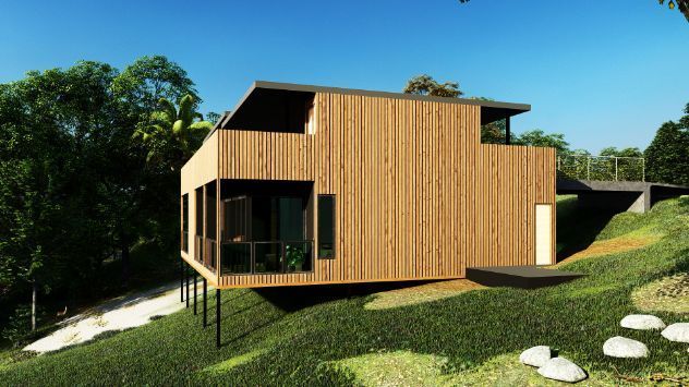 A Wooden House is Sitting on Top of a Hill Surrounded by Trees — Omni Builders In Bungalow, QLD
