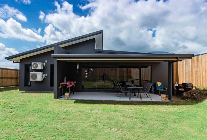 The Back of a House With a Patio and a Table and Chairs in the Backyard — Omni Builders In Bungalow, QLD