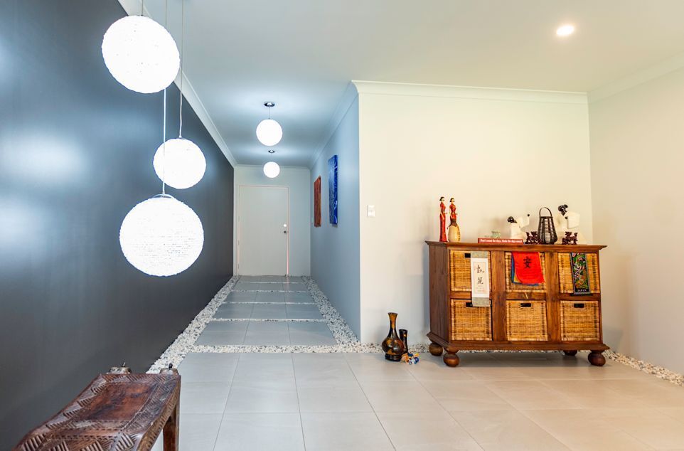 A Hallway With a Dresser and a Bench in It — Omni Builders In Bungalow, QLD