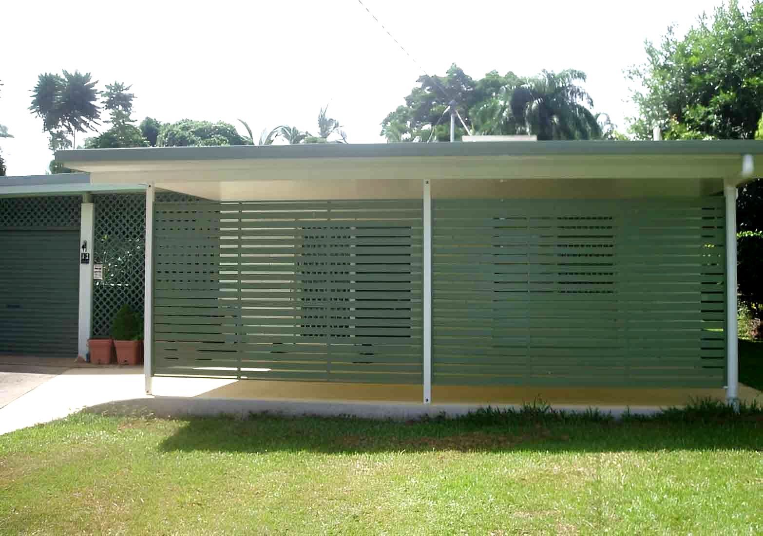 A House With A Fence Around It And A Lawn In Front Of It — Omni Builders In Bungalow, QLD