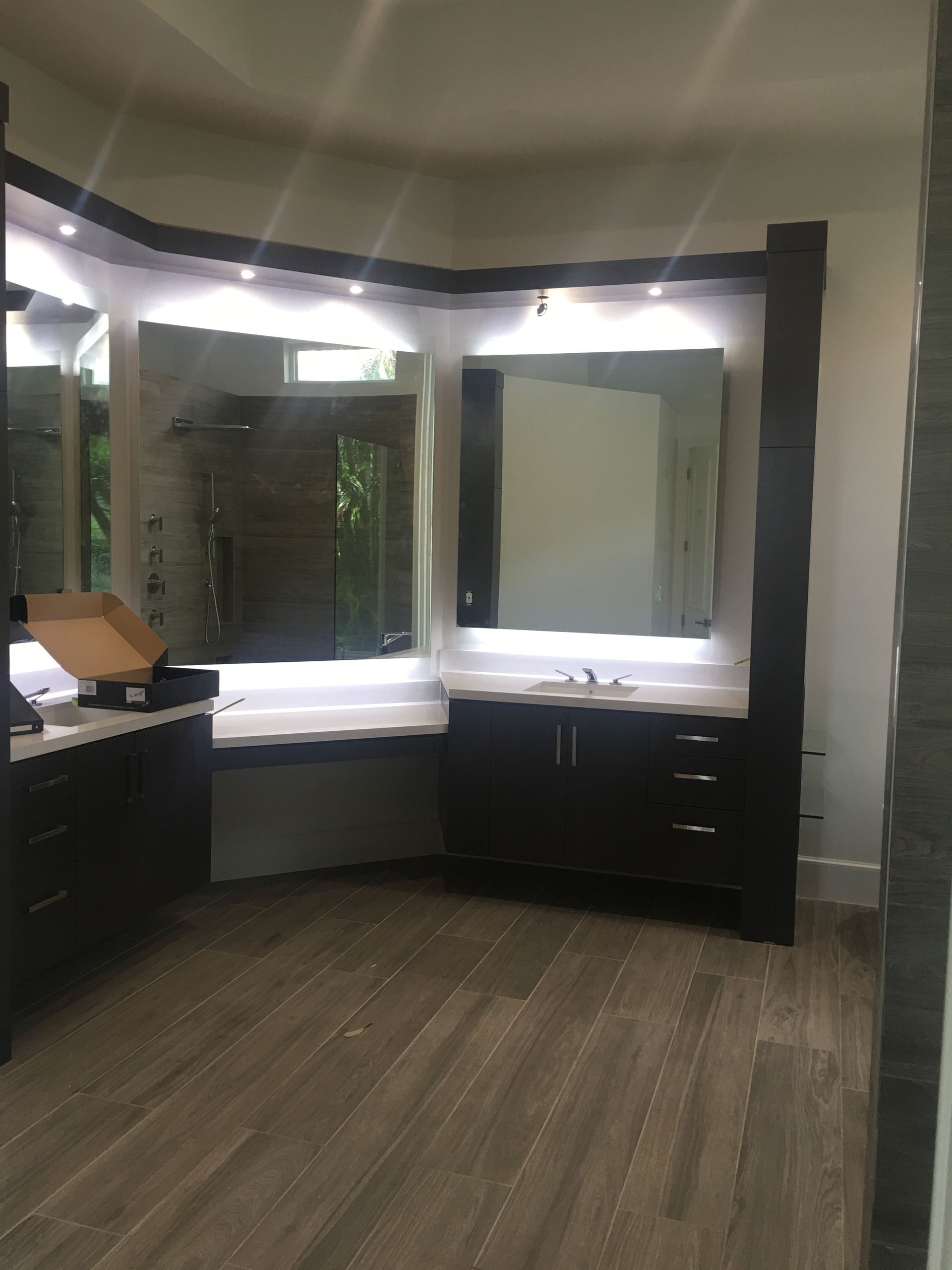 A bathroom with two sinks and a large mirror