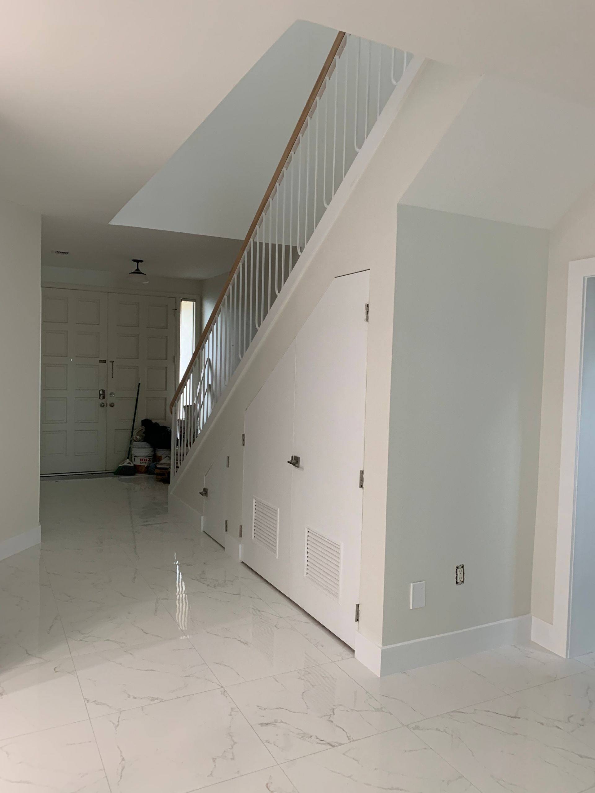 An empty room with a staircase leading up to the second floor