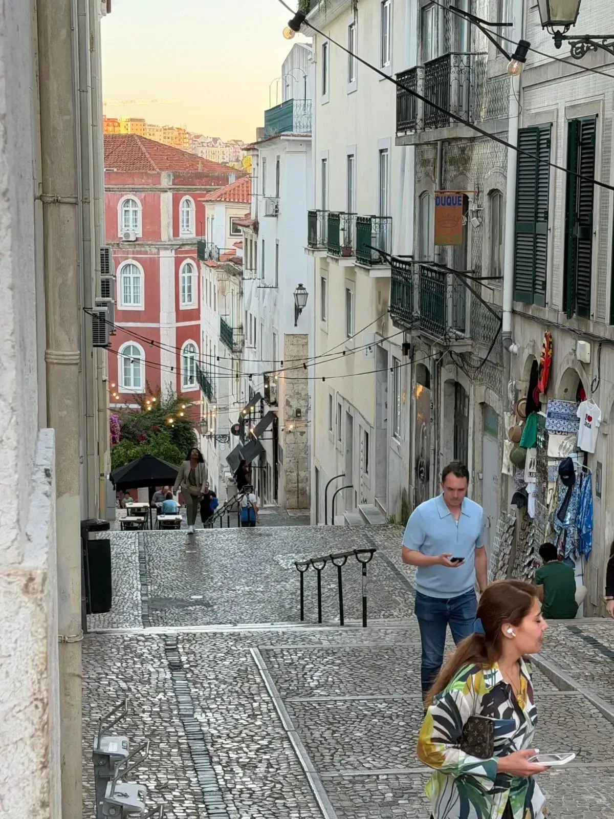 Travelers walking through a historic street in Lisbon's old town
