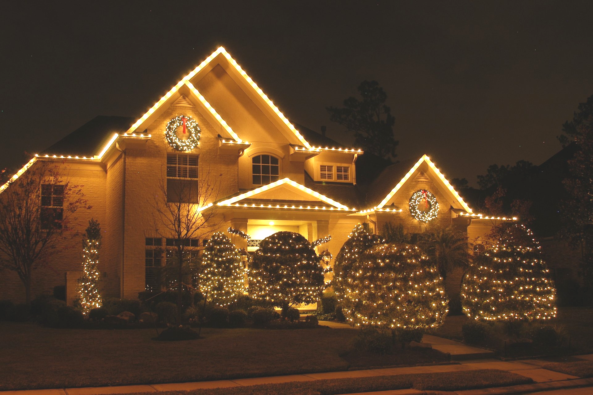 A house is decorated with christmas lights at night