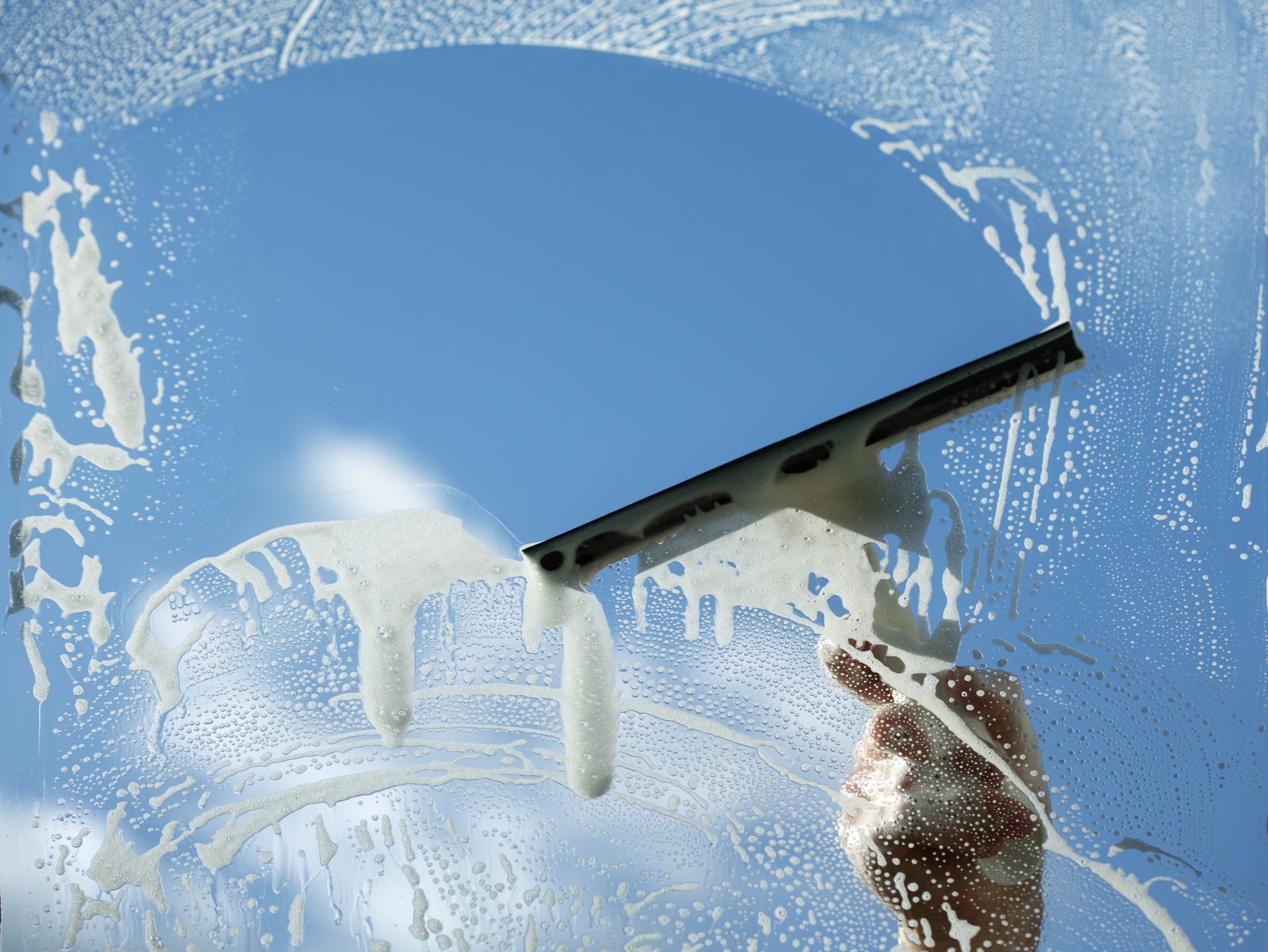 Cleaning the inside windows at Gastons restaurant using mop and squeegee