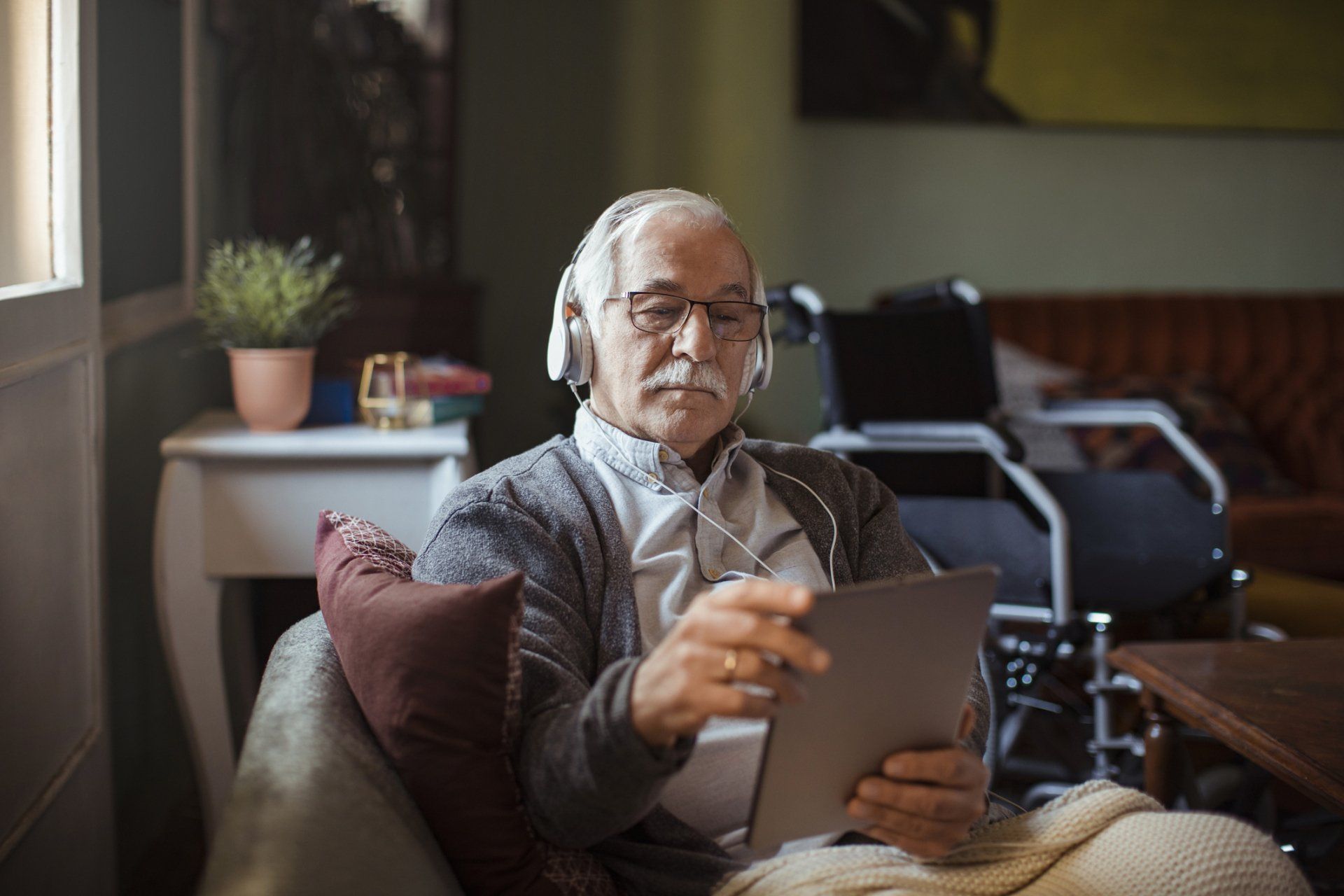 Senior Man Using a Tablet — Lakeland, FL — Better Living for Seniors of Polk County