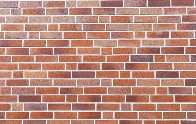 Red brick wall with white mortar and a few dark gray bricks