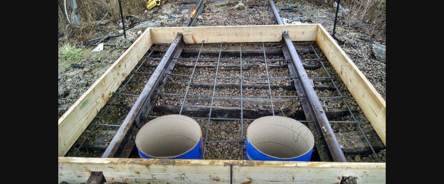 Two blue barrels are sitting in a wooden box.
