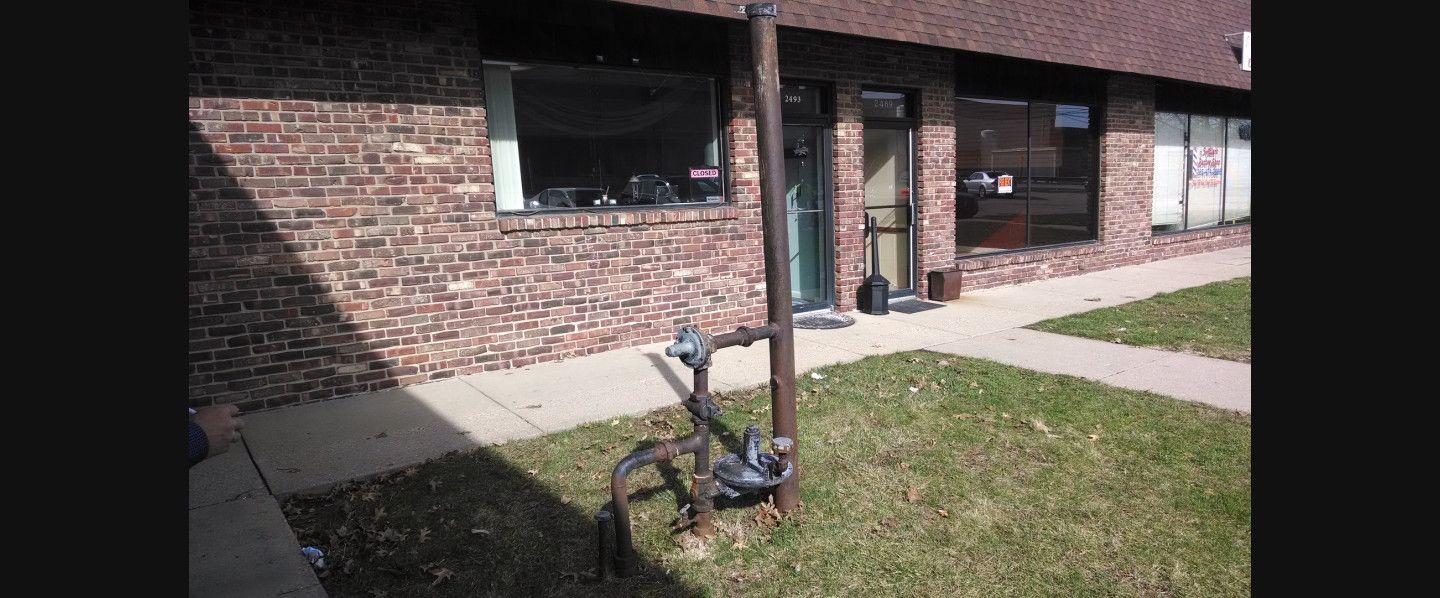 A bicycle is parked in front of a brick building