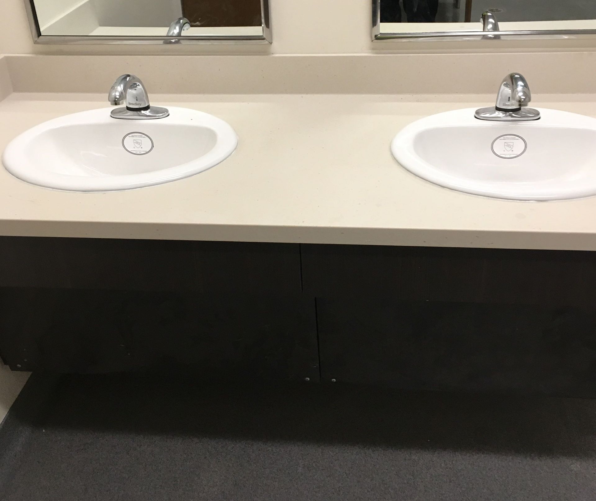 A bathroom with two sinks and a mirror