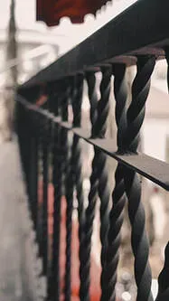 wrought iron railing outside on balcony at apartment building