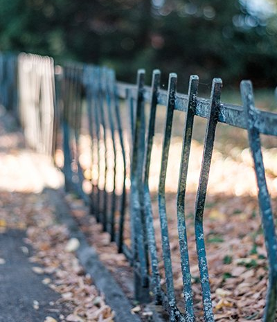 old fence, wrought iron in need of repair, sidewalk fence