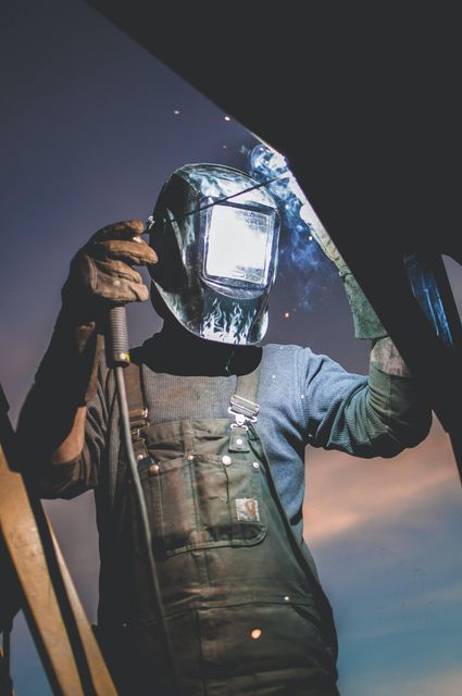 stick welding on large machinery with welding mask