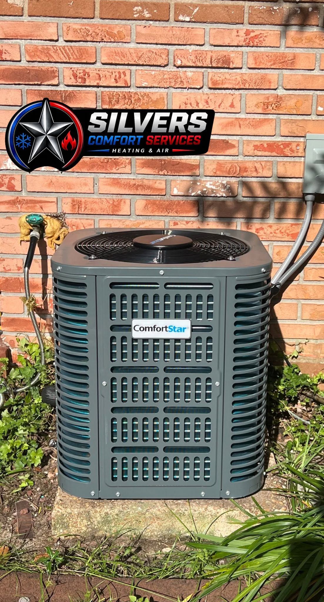 Outdoor HVAC unit against a brick wall with a Silvers sign above it