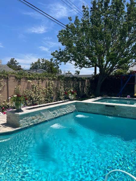 A large swimming pool with a tree in the background