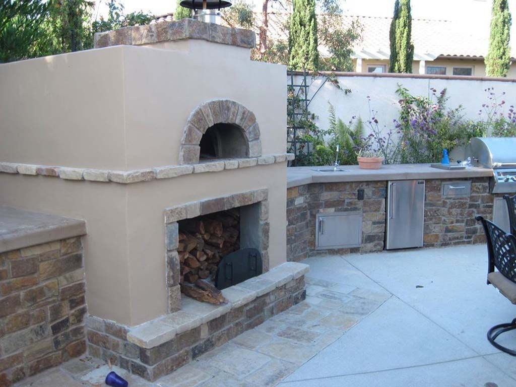A pizza oven is built into the side of a building