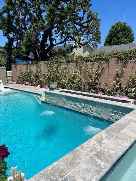 A large swimming pool with a fountain in the middle