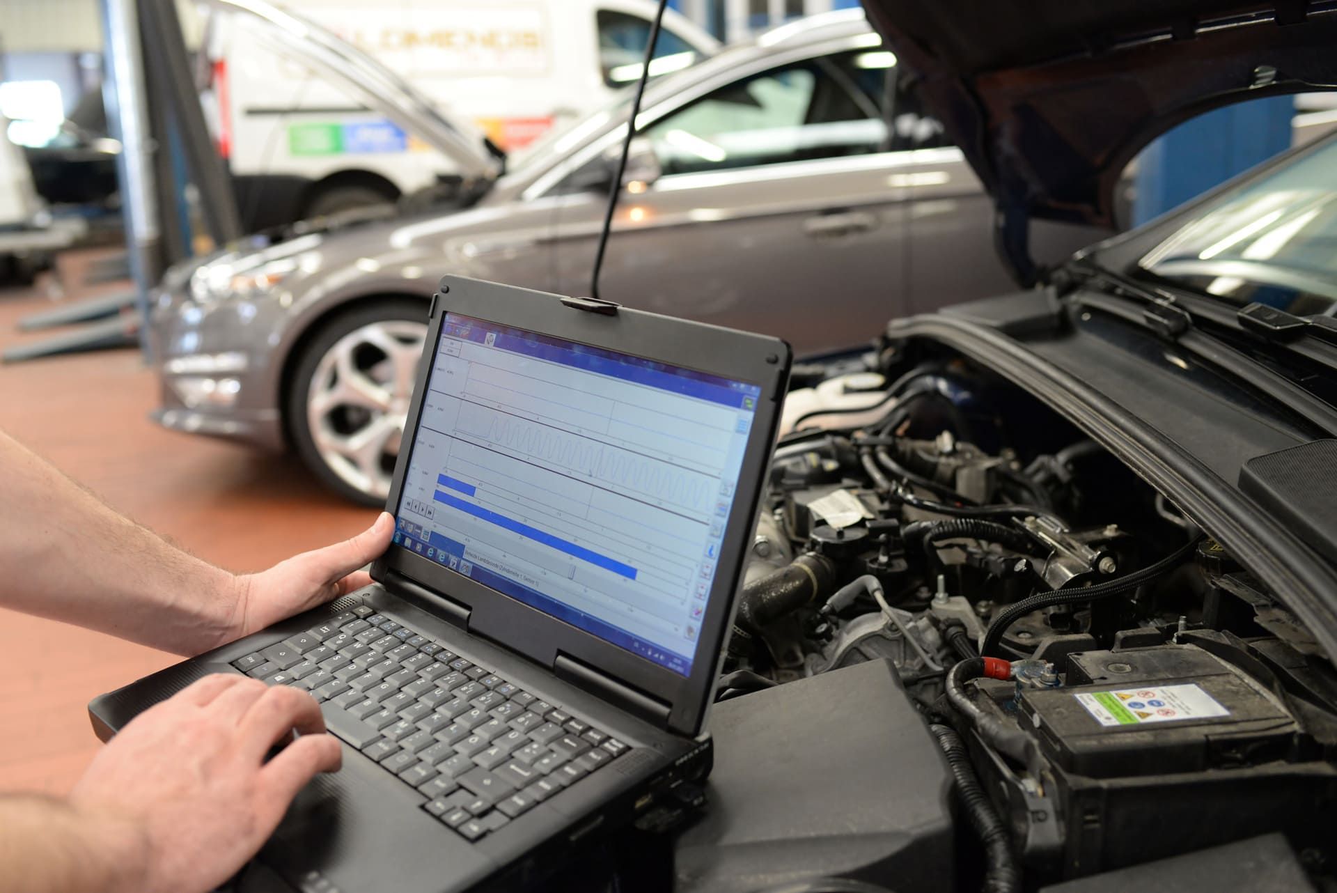 laptop plugged into a car engine