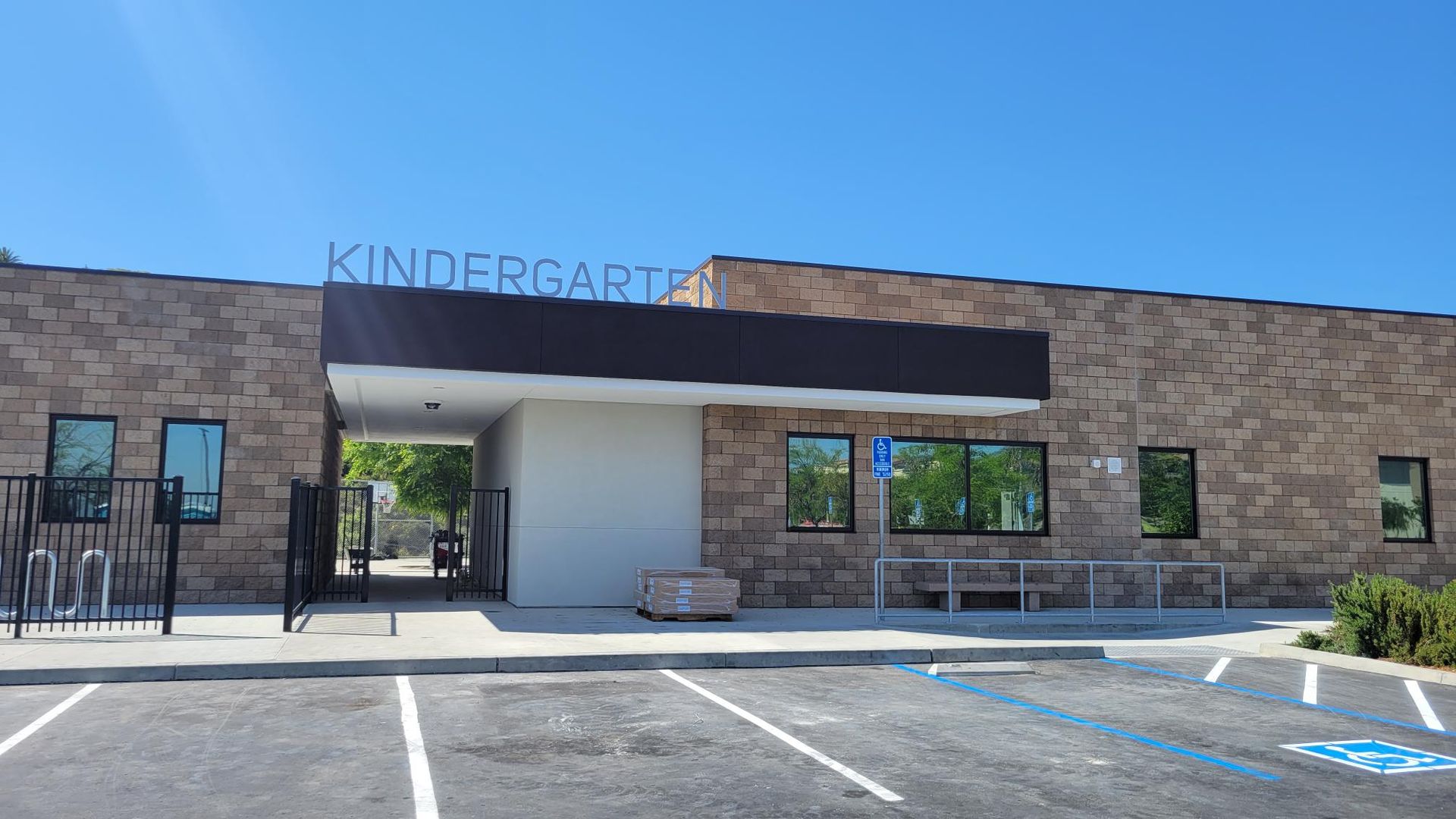 A kindergarten building with a handicapped parking spot in front of it.