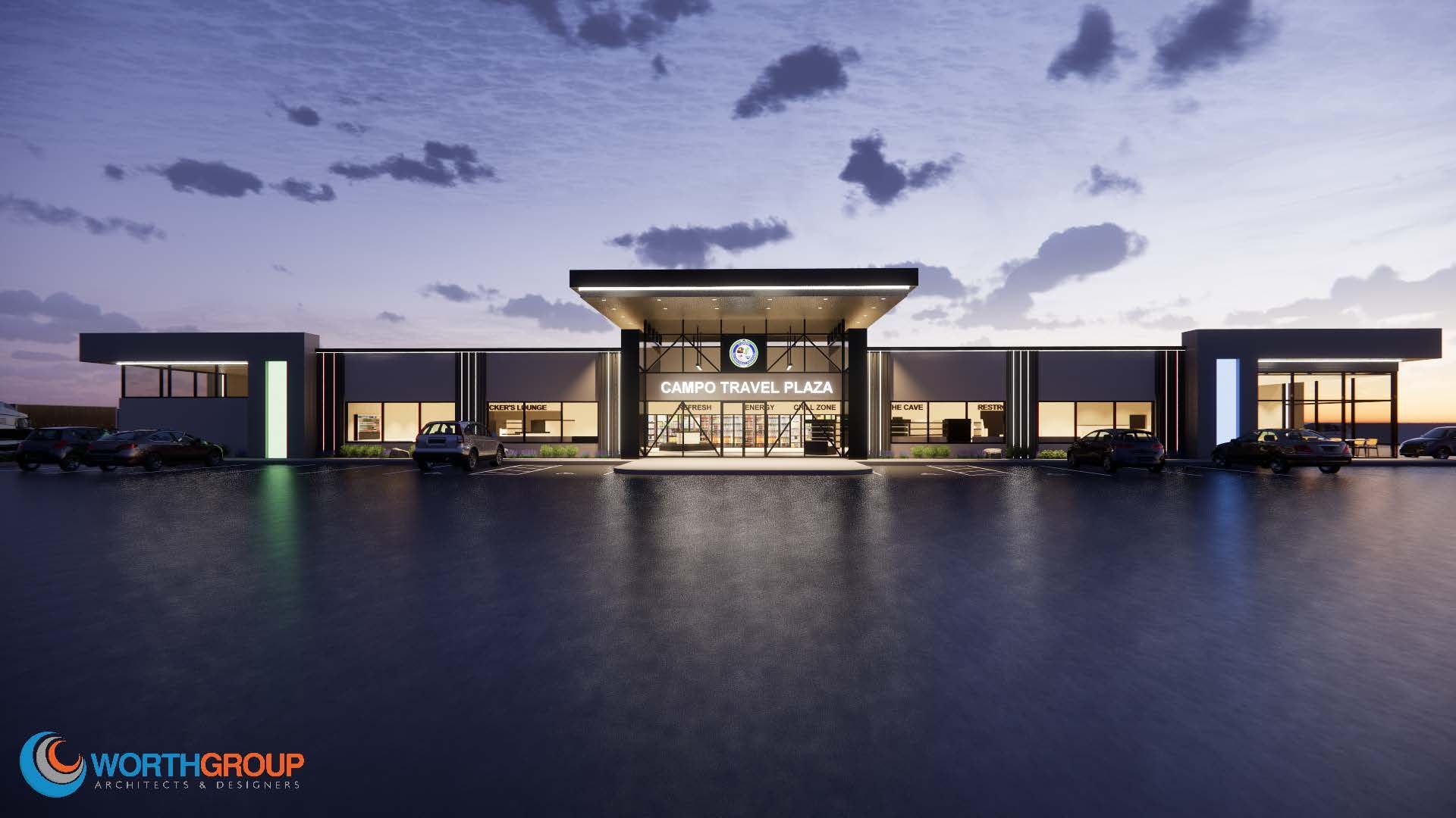Modern building with a large entrance, reflecting light at dusk. Gray walls, glass windows, and cars in front.