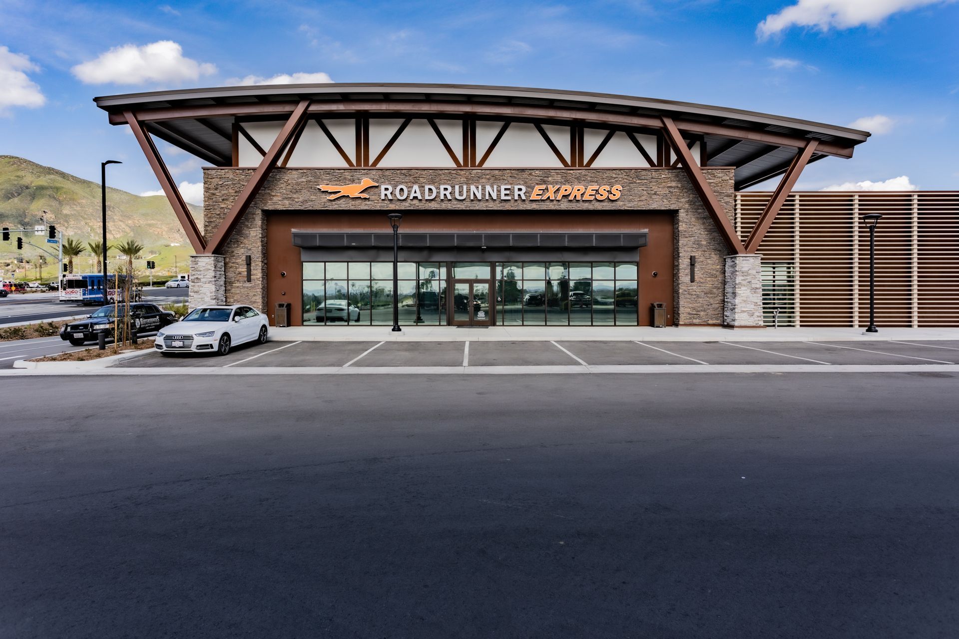A large building with cars parked in front of it.
