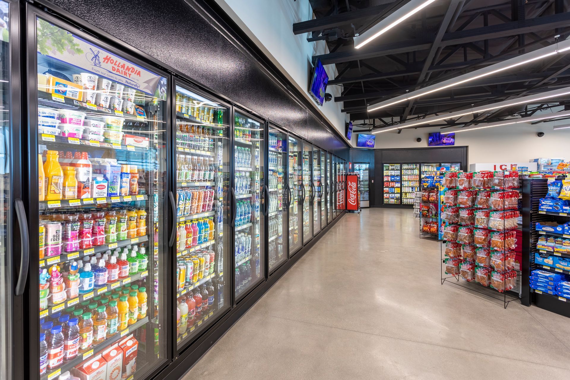 A grocery store filled with lots of fridges and shelves.