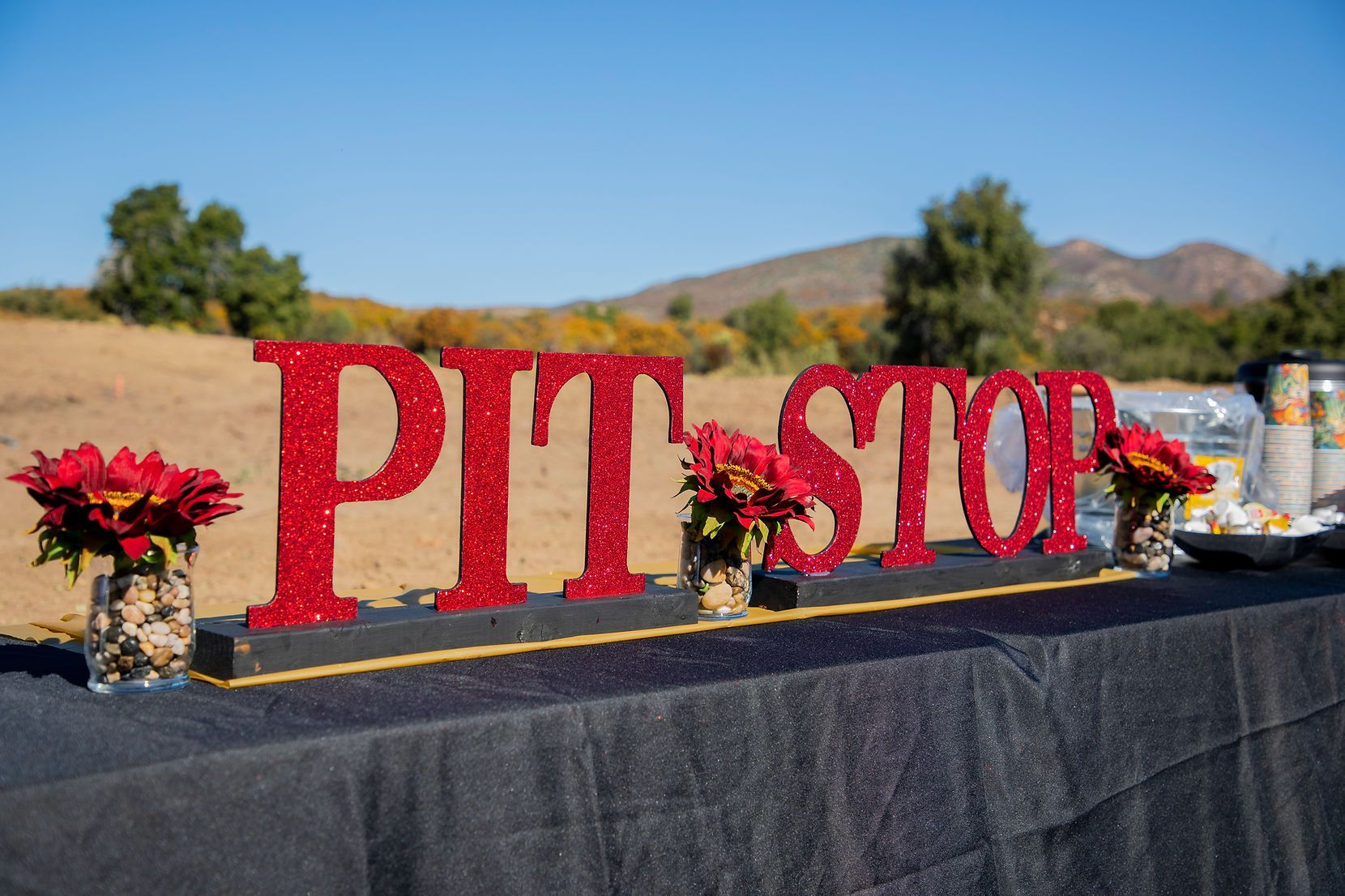 A table with a sign that says pit stop on it.