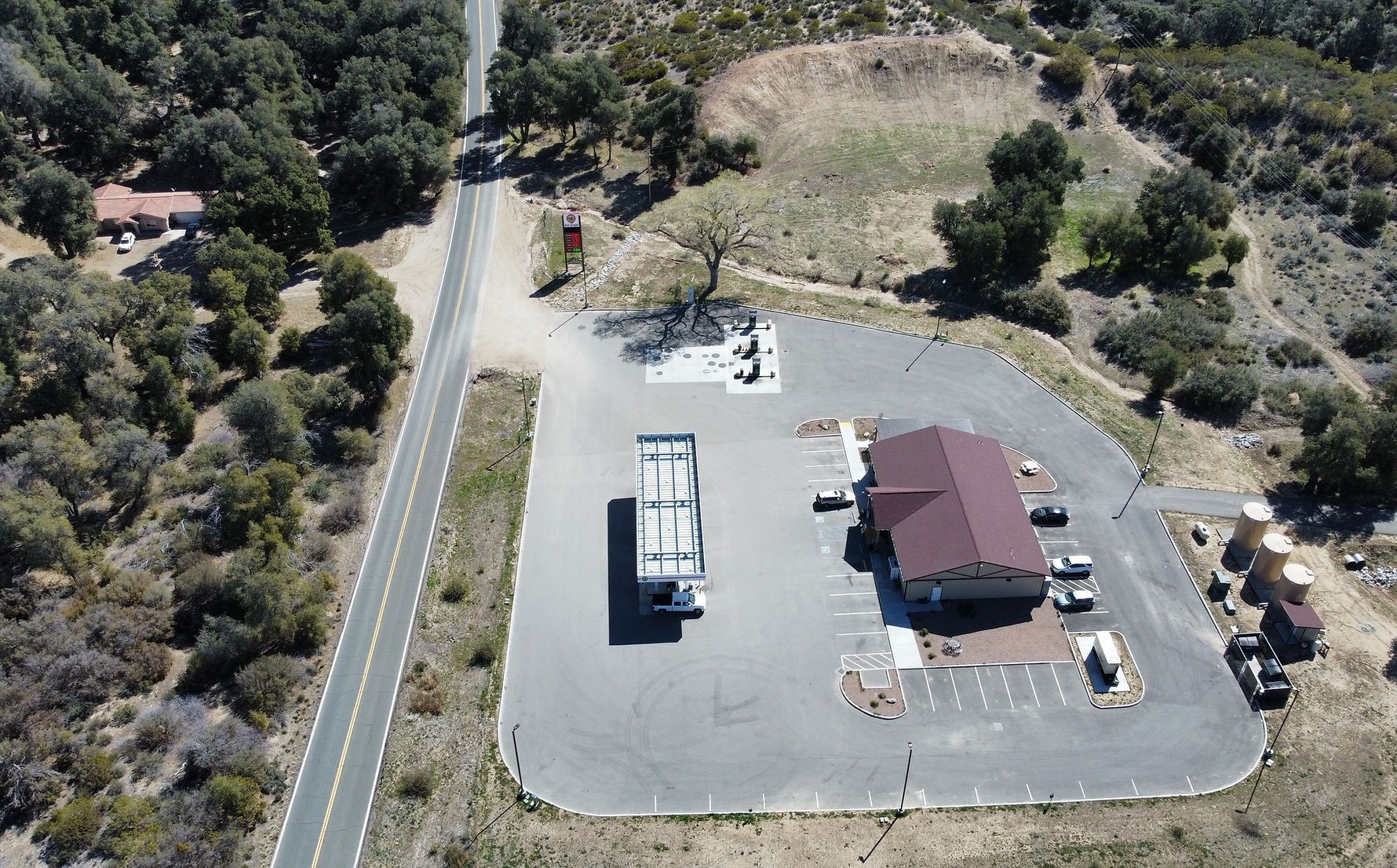 An aerial view of a gas station in the desert