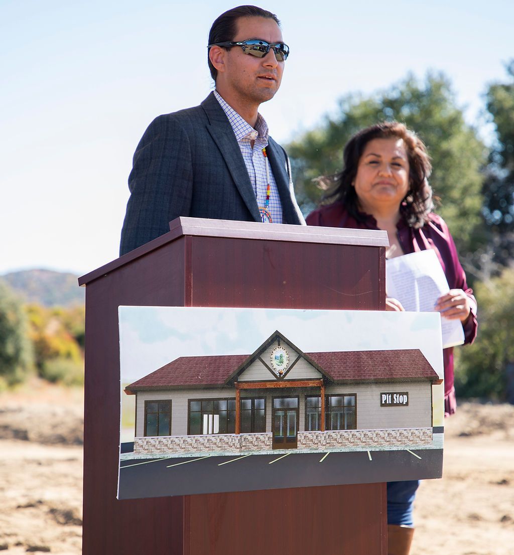 A man stands at a podium with a picture of a house on it