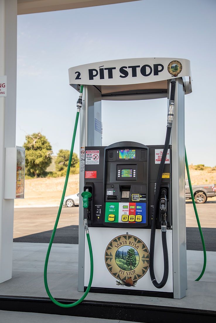 A gas pump at a gas station that says 2 pit stop