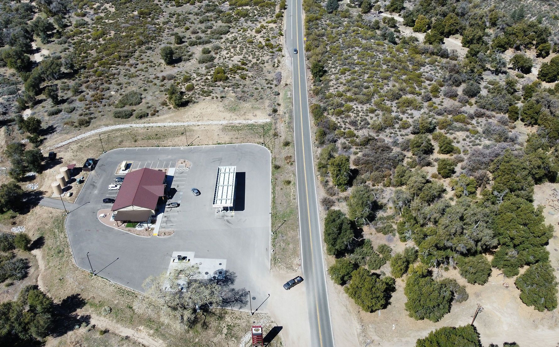 An aerial view of a rv parked in a parking lot next to a road.