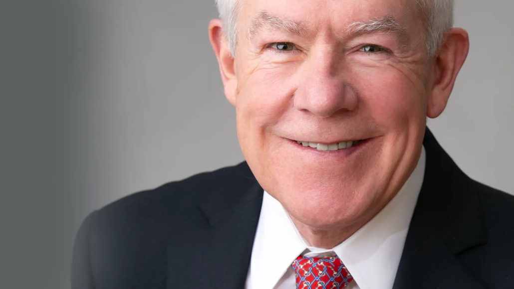 A man in a suit and tie is smiling for the camera.