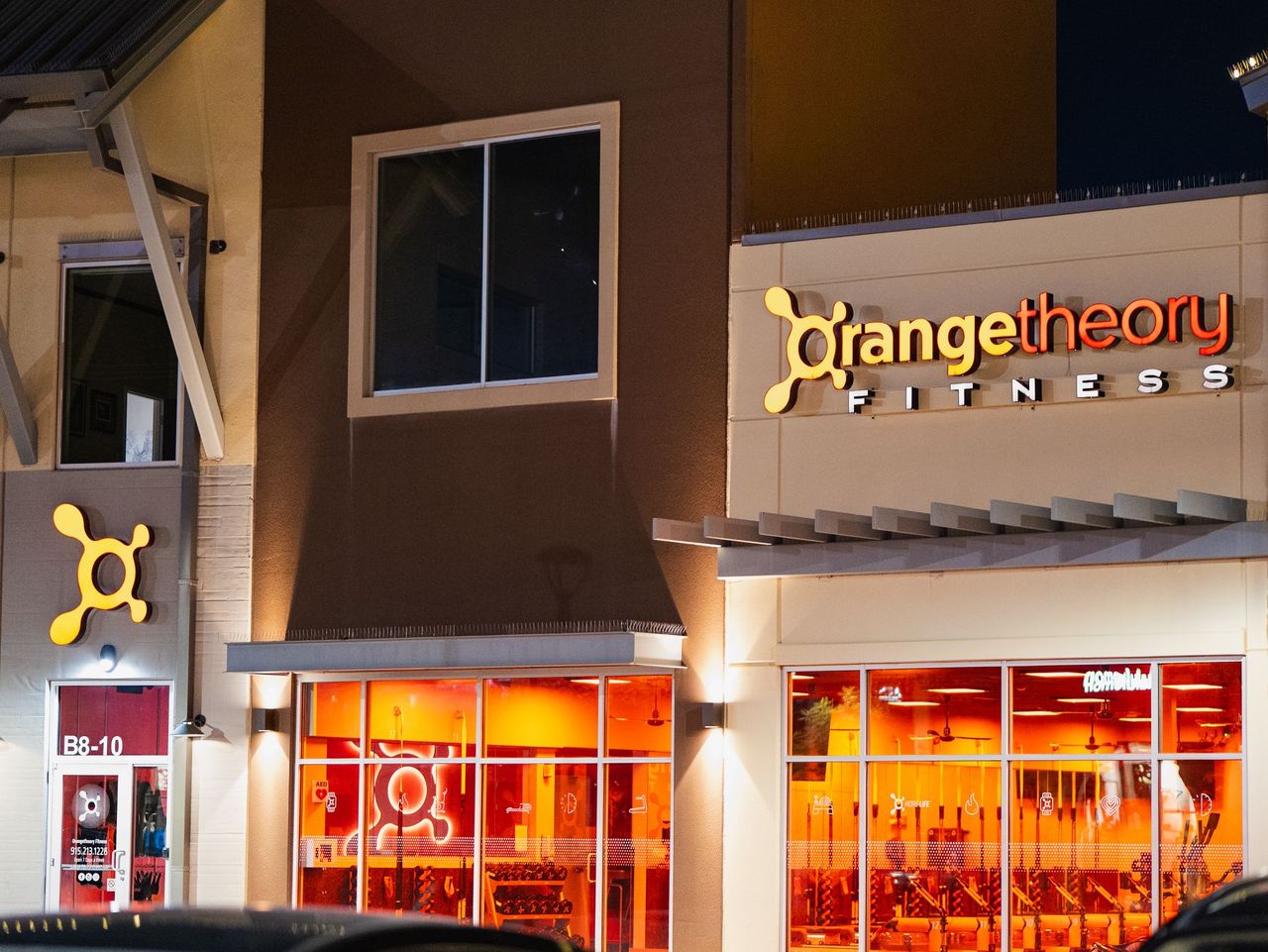 Illuminated storefront sign at night