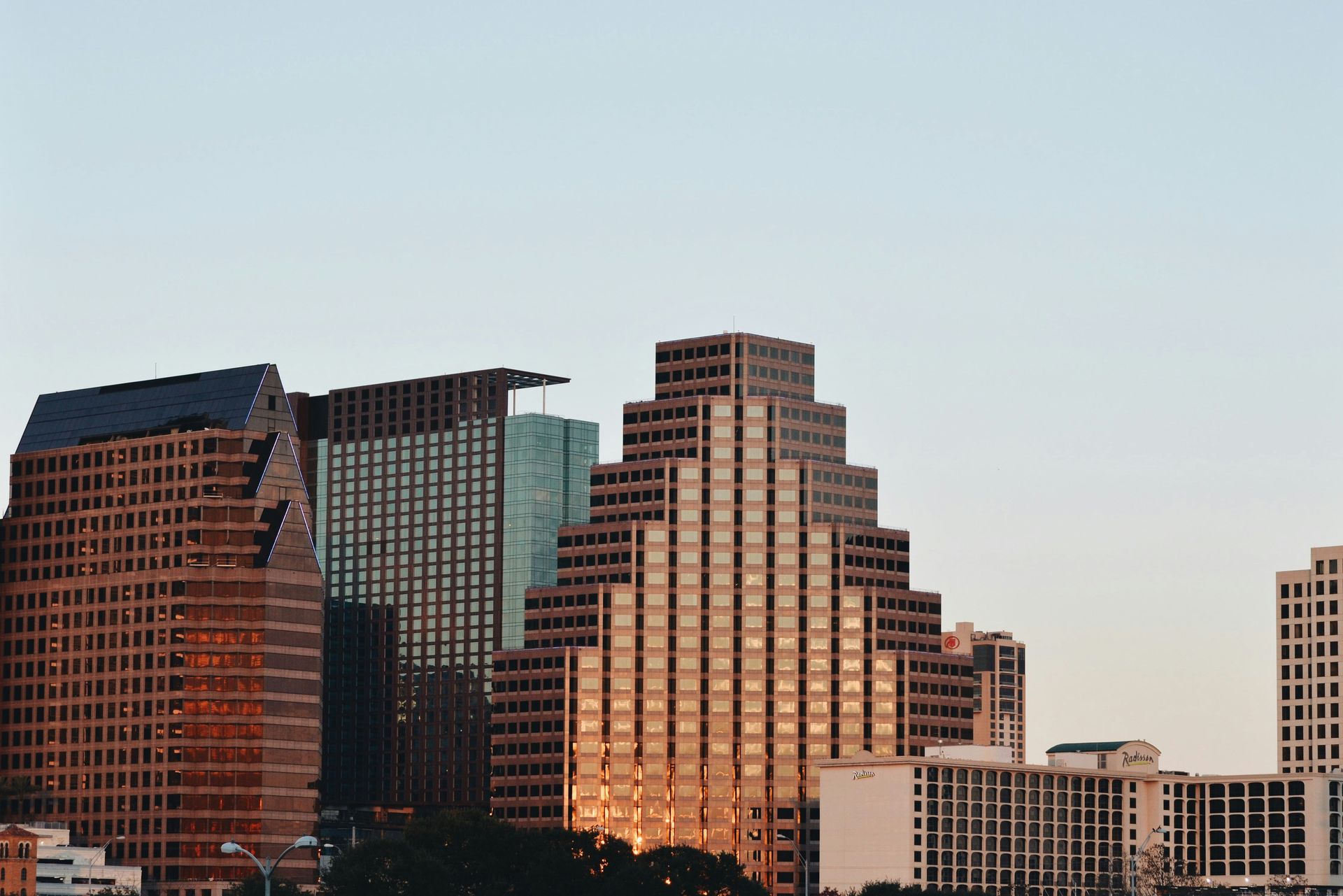 City skyline at dusk with brown and golden skyscrapers.