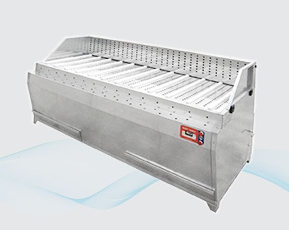 Stainless steel industrial machine with sloped conveyor belts and perforated top panels