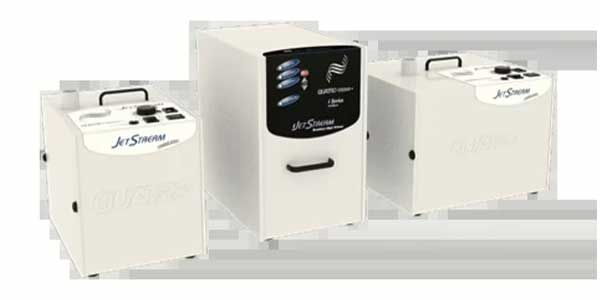 Three compact white appliance units with black tops on a light background