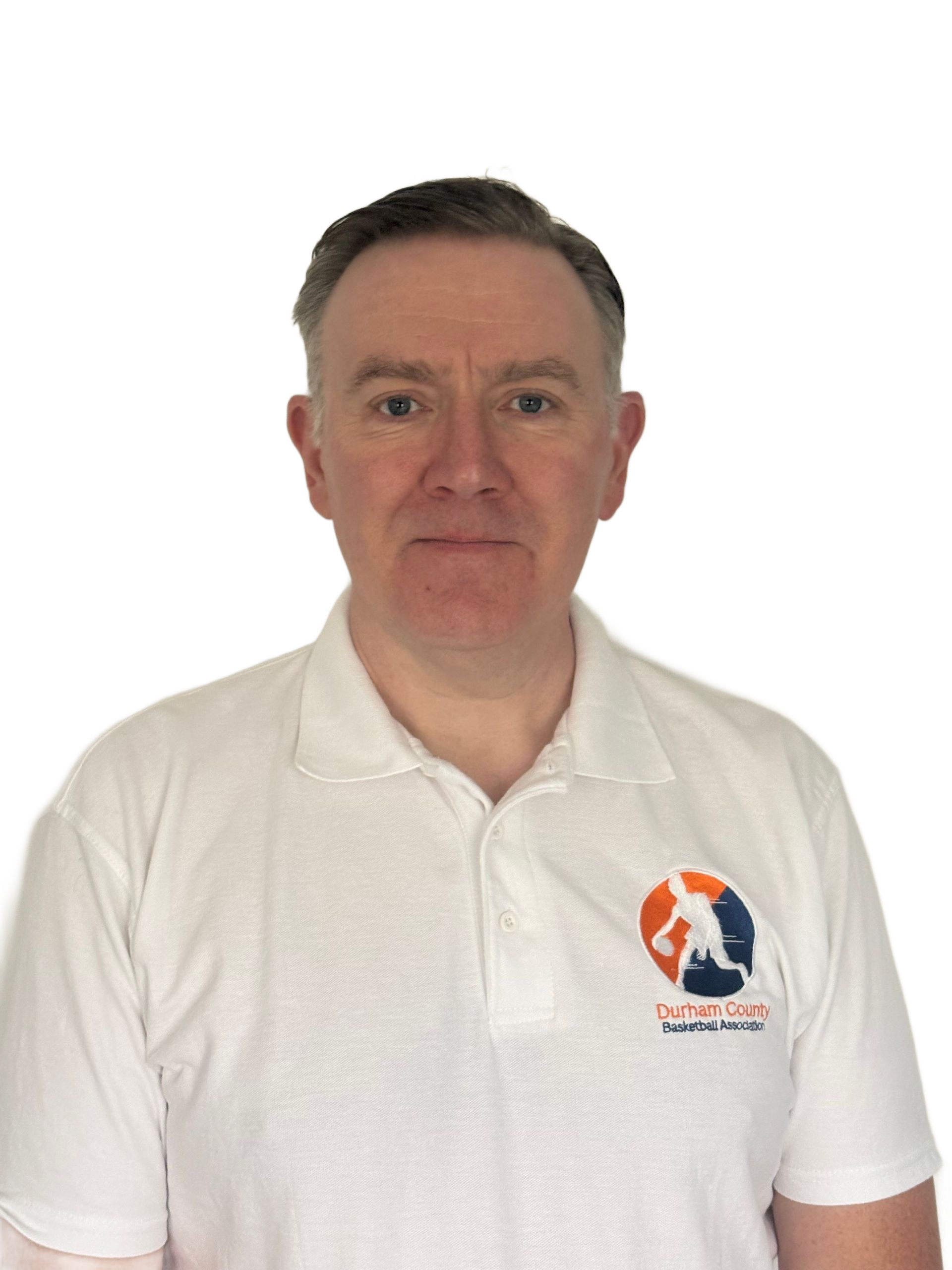Person in a white polo shirt with a logo, standing against a plain beige wall.