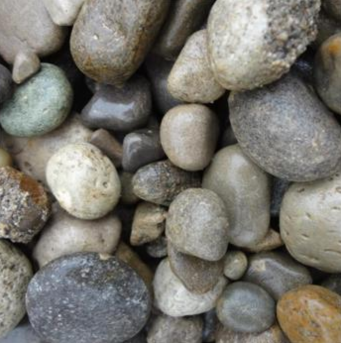 A collection of smooth, multi-colored river stones and pebbles of varying sizes and shapes.