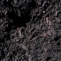 A close-up, top-down view of dark brown garden mulch with varying sizes of wood chips and organic material.