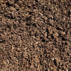 A close-up view of dark, coarse, textured organic compost or potting soil.