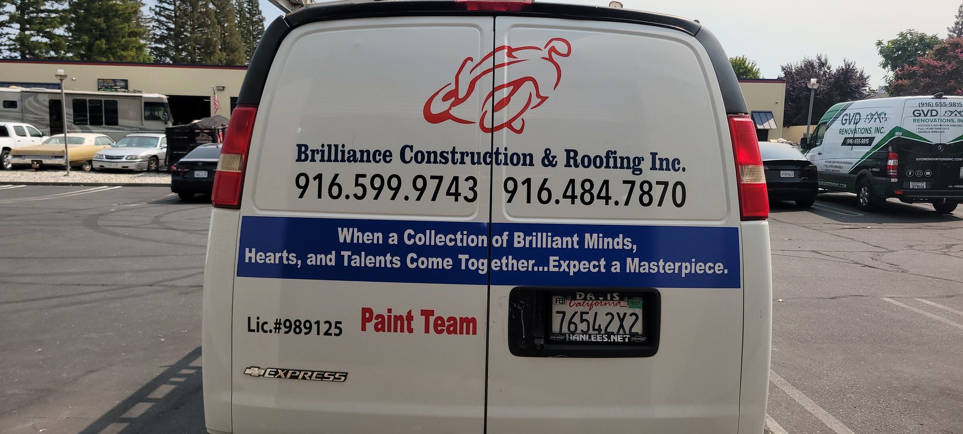 White van with Brillas Construction & Roofing ad and phone number, parked outdoors.
