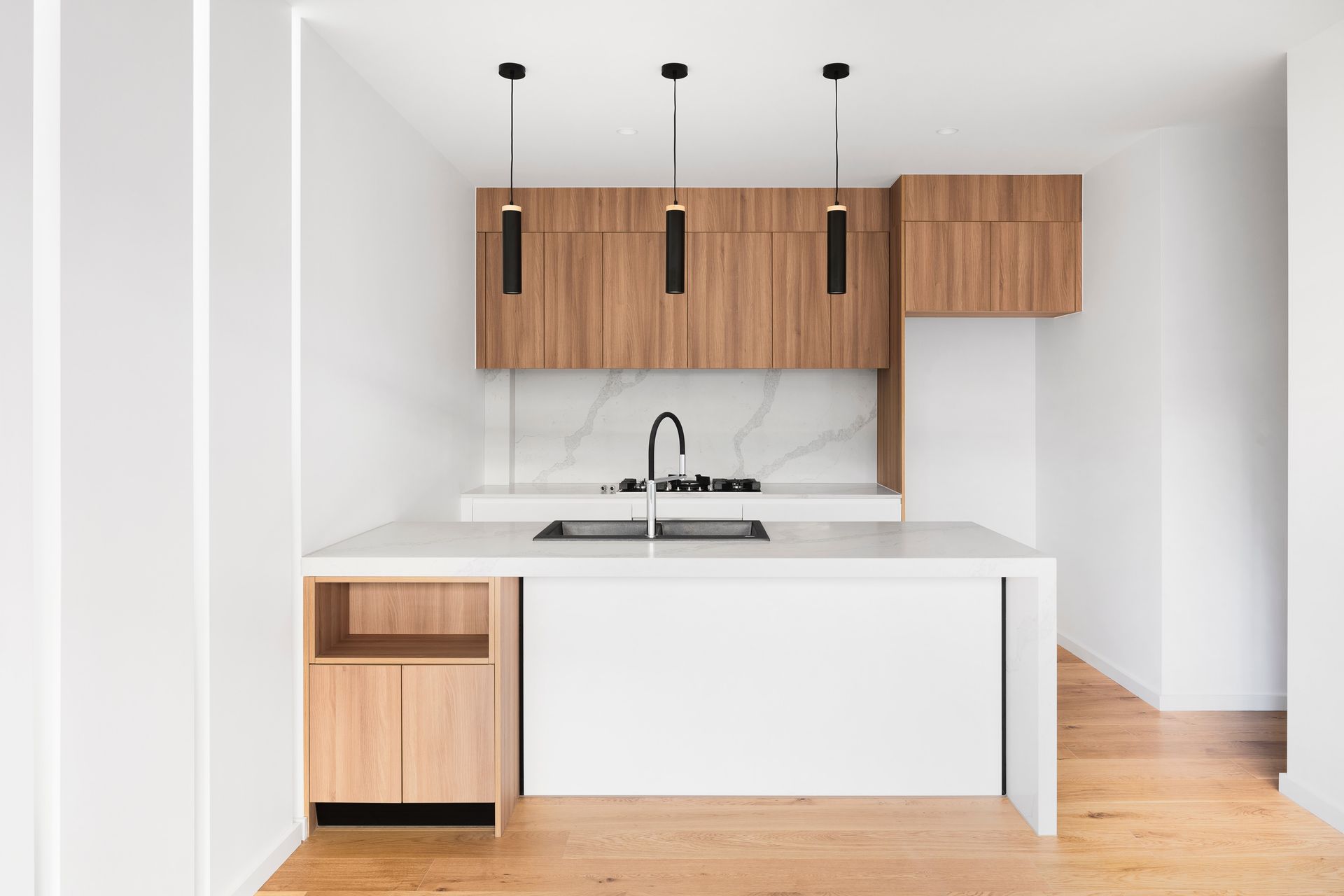A kitchen with wooden cabinets and white counter tops